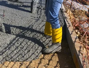 Student gaining hands-on experience finishing concrete, representing ACI Carolinas Student Membership.