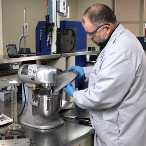 Laboratory technician performing ASTM physical testing of cementitious materials for ACI Cement Physical Tester certification.