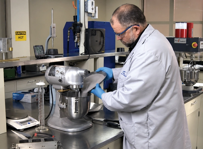 Laboratory technician performing ASTM physical testing of cementitious materials for ACI Cement Physical Tester certification.