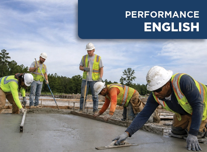 Multi-racial concrete flatwork crew finishing a freshly placed concrete slab during a hands-on performance exam.