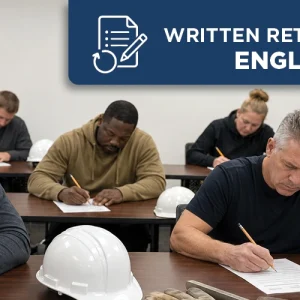 Concrete construction professionals taking an English written retest in a classroom with hard hats and flatwork tools nearby.