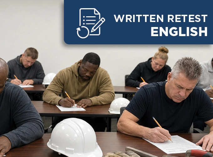 Concrete construction professionals taking an English written retest in a classroom with hard hats and flatwork tools nearby.