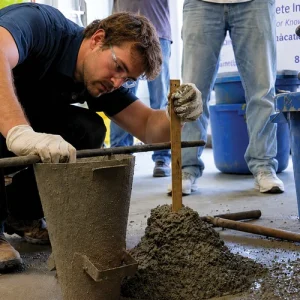 Concrete testing technician measuring slump during a Field Grade 1 / NCDOT concrete testing demonstration.