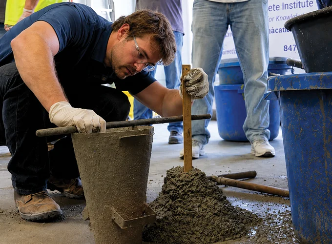 Concrete testing technician measuring slump during a Field Grade 1 / NCDOT concrete testing demonstration.